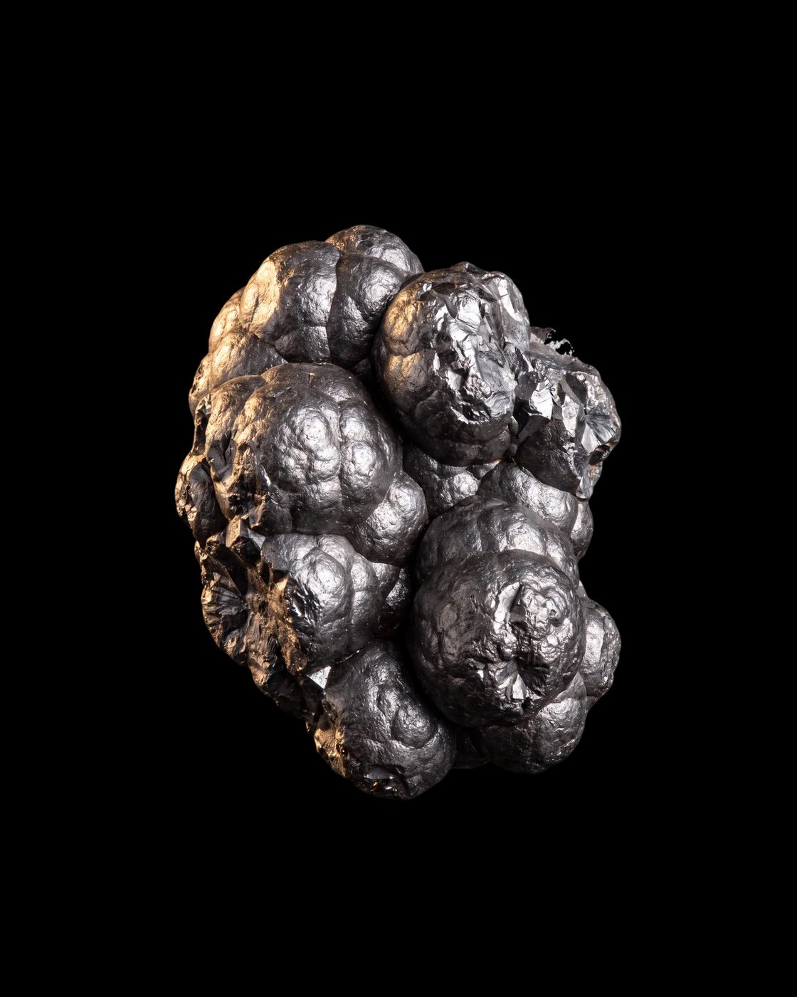 Black, metallic manganese ore with a rounded, grape-like surface